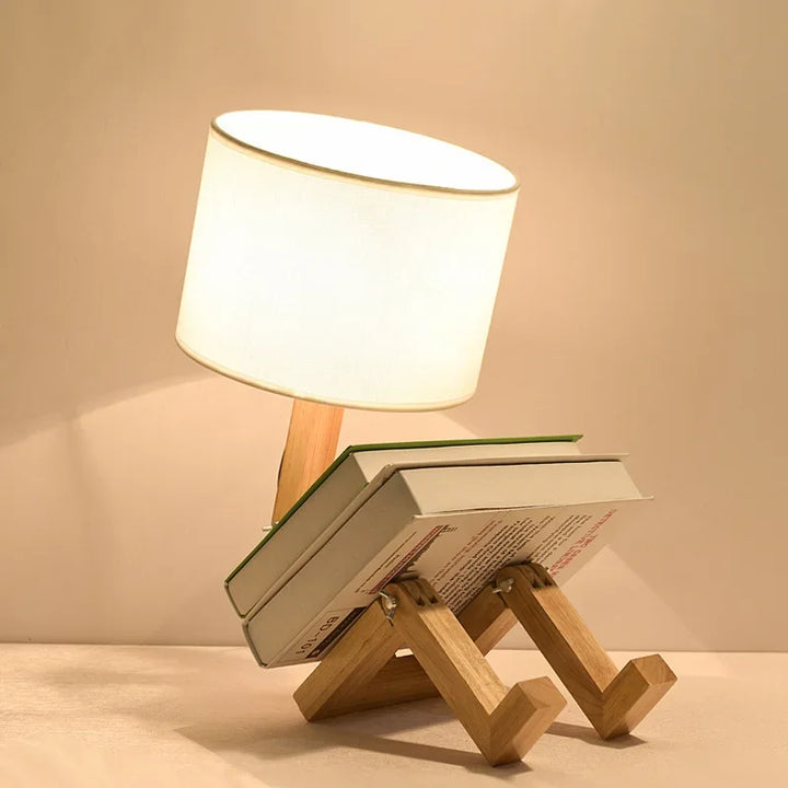 Smart wooden robot lamp: adjustable desk light, fabric shade, integrated book holder. Enhance your study space.