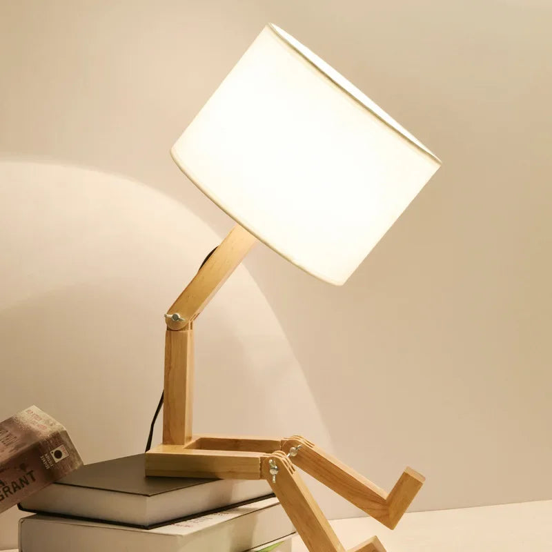 Playful wooden robot table lamp with integrated book holder. Perfect for kids' rooms or unique home lighting.