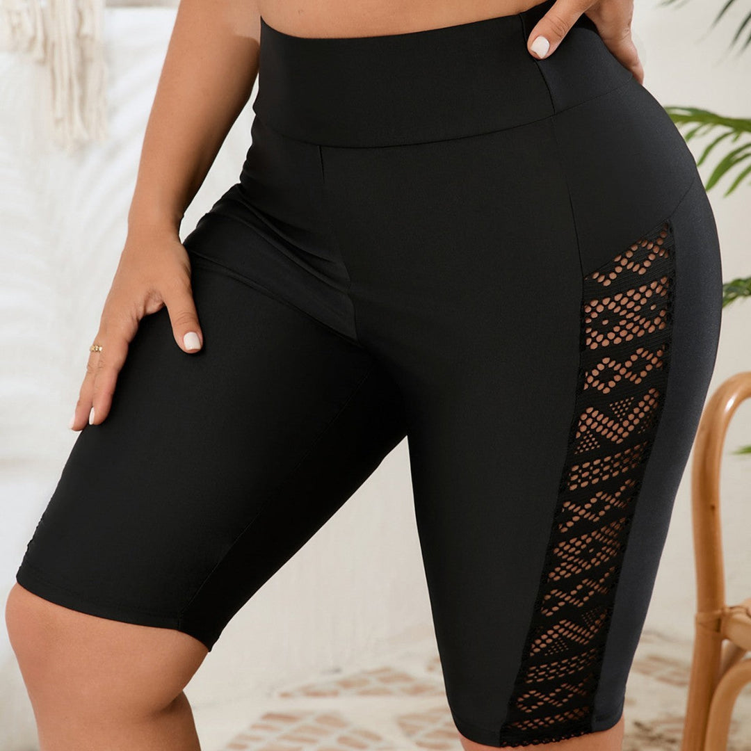 Black high-waisted bike shorts for women, featuring stylish mesh panels. Perfect for yoga, gym, or running.