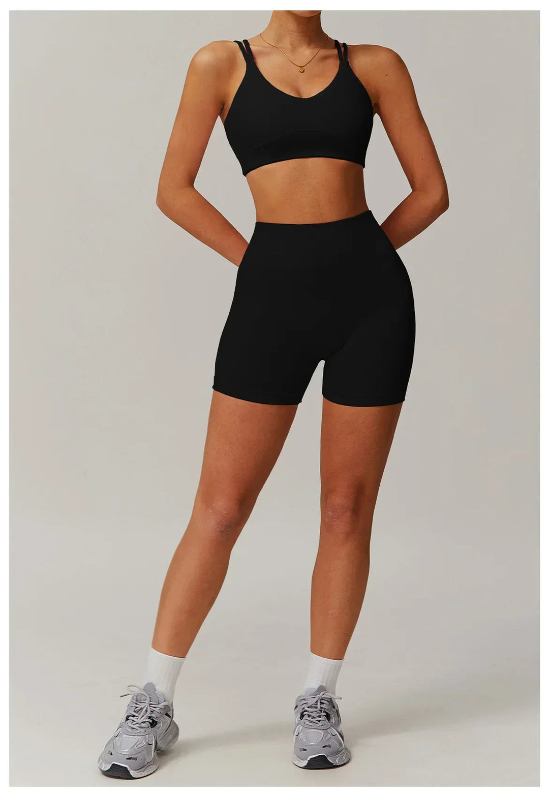Athletic women's workout set featuring a high-waisted bike shorts and crop top. Ideal for gym and yoga.
